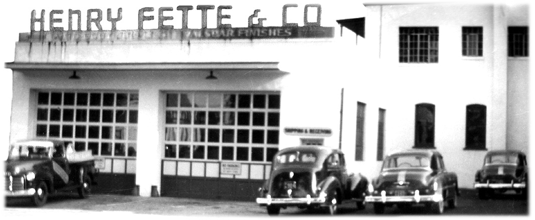 Black and white photo of Henry Fette & Co building with 1940s-era cars parked outside.